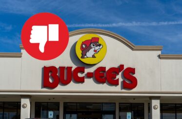 Buc-ee's sign on a restaurant with a big white thumbs down in a red circle next to it