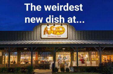 Cracker Barrel sign over a store at night with white text above that reads: "The weirdest new dish at..."