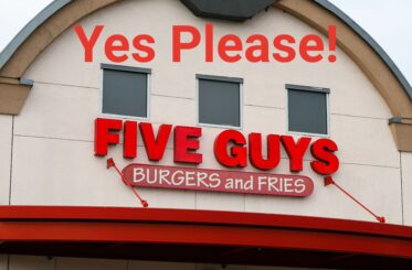 Five Guys Burgers and Fries logo on a building with "Yes Please!" written above in red letters