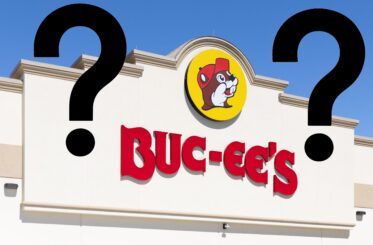 Buc-ee's logo on a sign with two big question marks next to it, one on each side