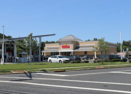 Picture of a Wawa with cars parked in front