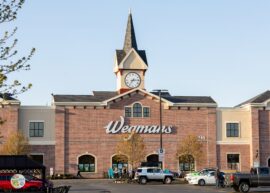 Wegmans logo on a building with a clock tower up above