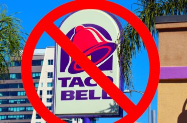 Taco Bell sign with a "no" sign on top of it.