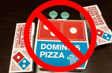 Domino's pizza boxes with a big red cancel sign over them
