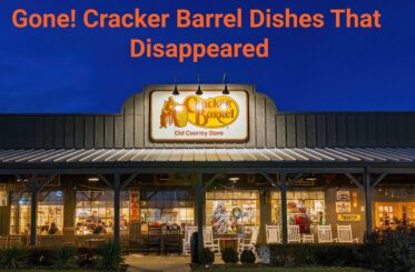 Cracker Barrel restaurant lit up at night with this text above it: "Gone! Cracker Barrel Dishes That Disappeared"