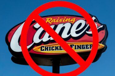 Raising Cane's sign with a big red cancel symbol over it