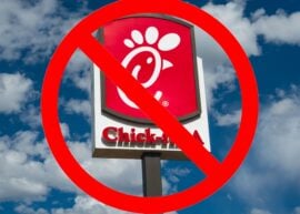 Chick-fil-A sign with a big cancel symbol over it, and clouds behind