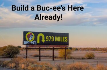 Buc-ee's sign showing a u-turn and "979 miles" with text above that says: "Build a Buc-ee's Here Already!"