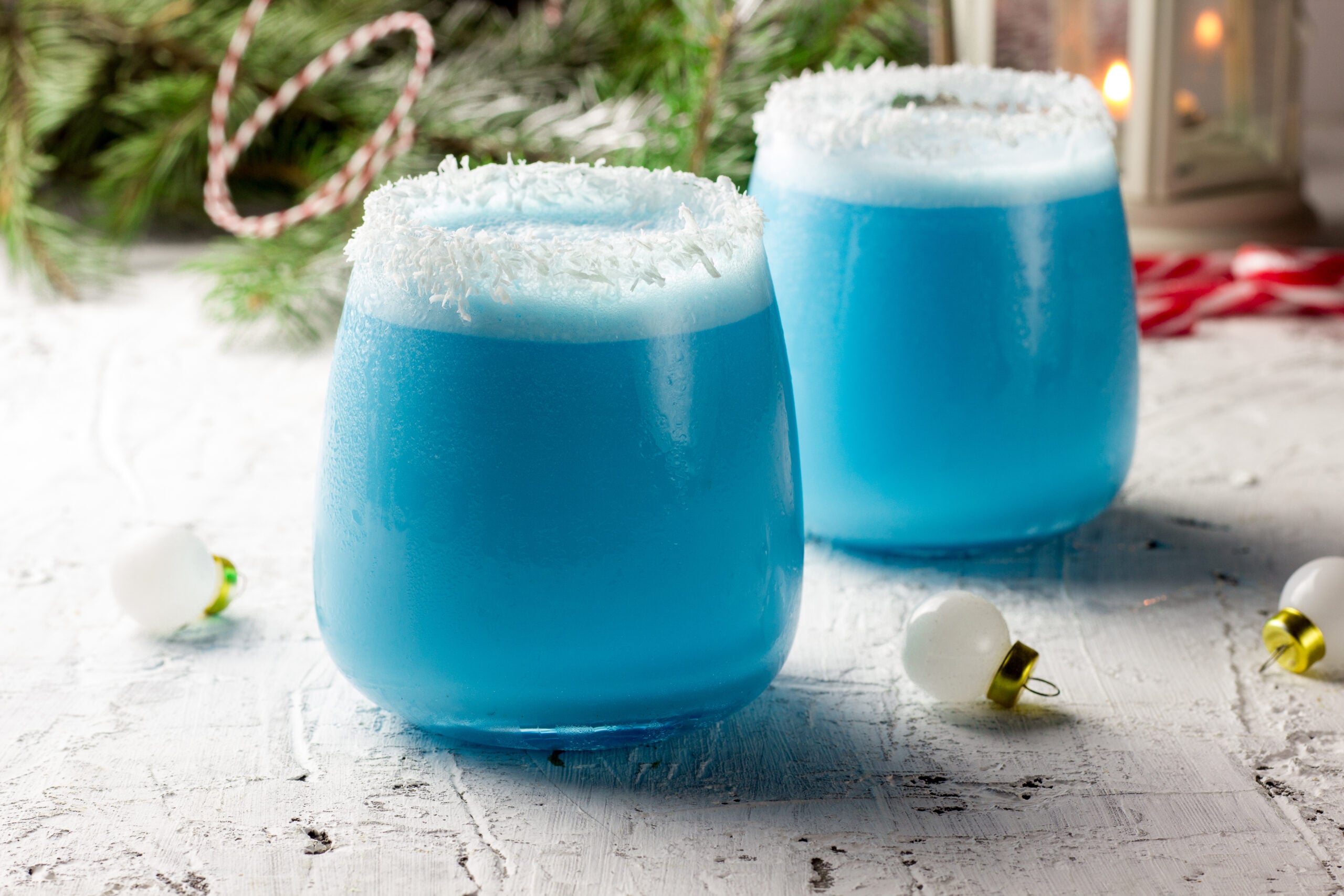 Two glasses of Jack Frost cocktail on a Christmas table.