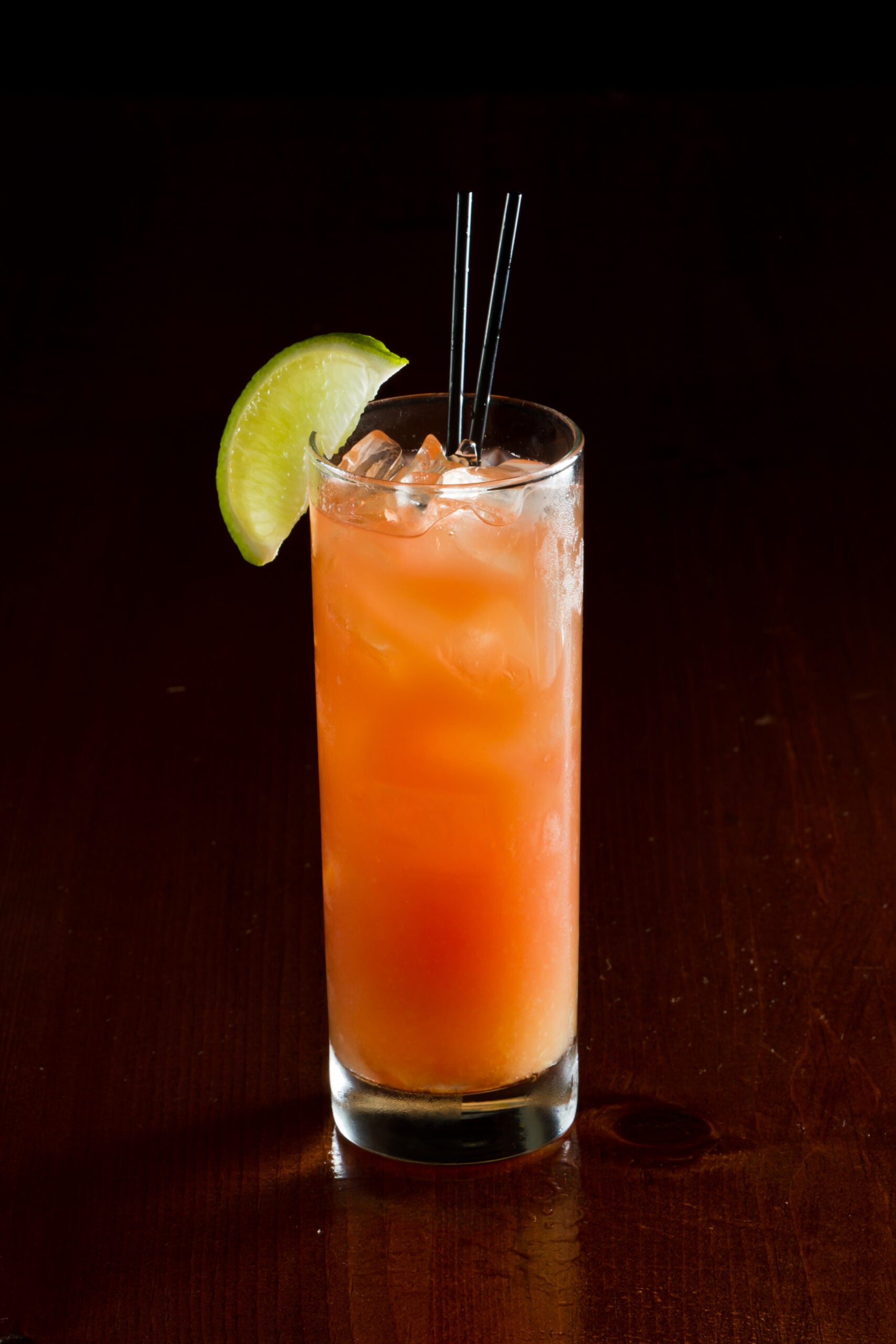 A black backdrop featuring a glass of Madras. 