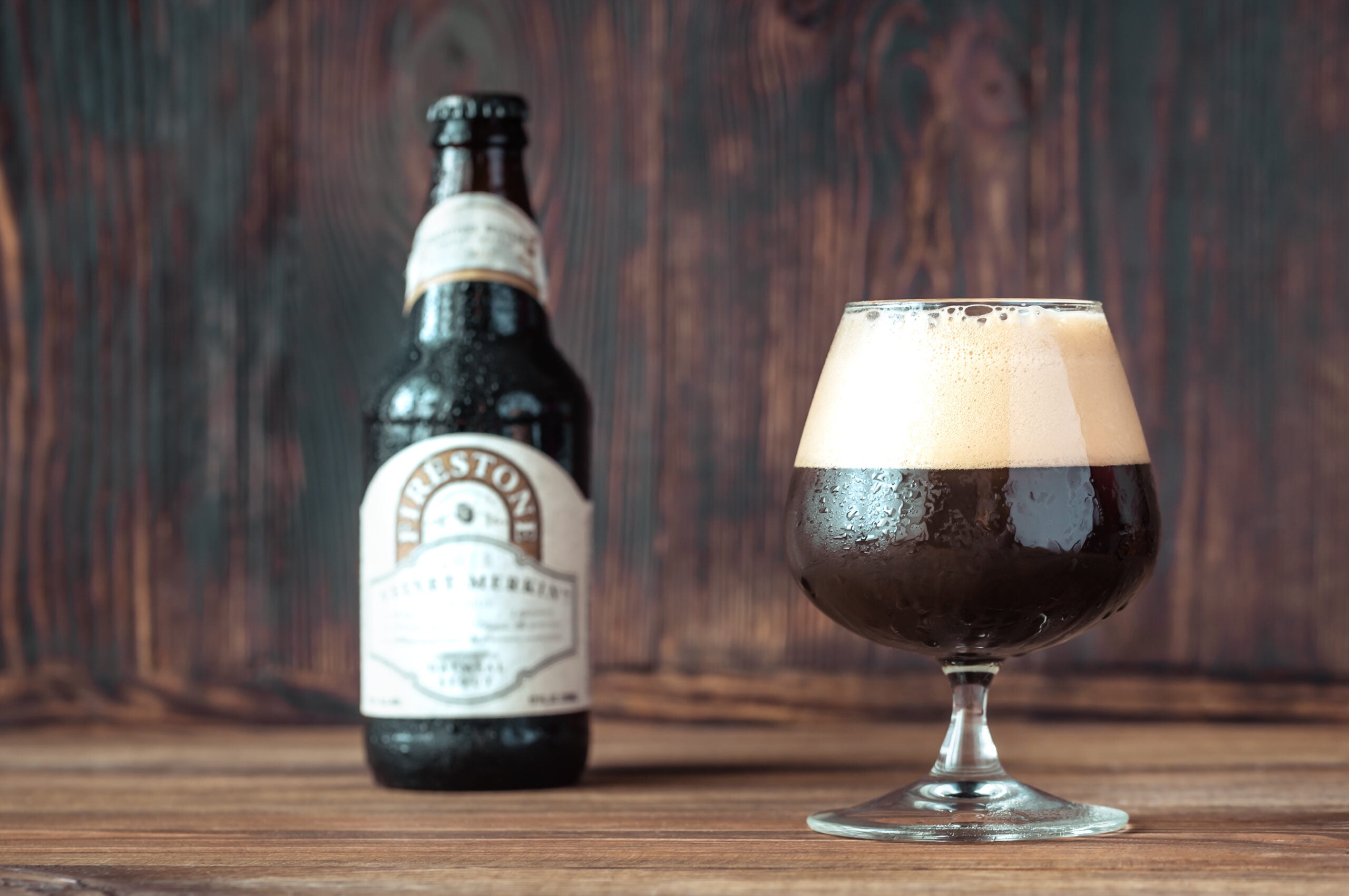 A bottle and glass of refreshing oatmeal stout beer. 