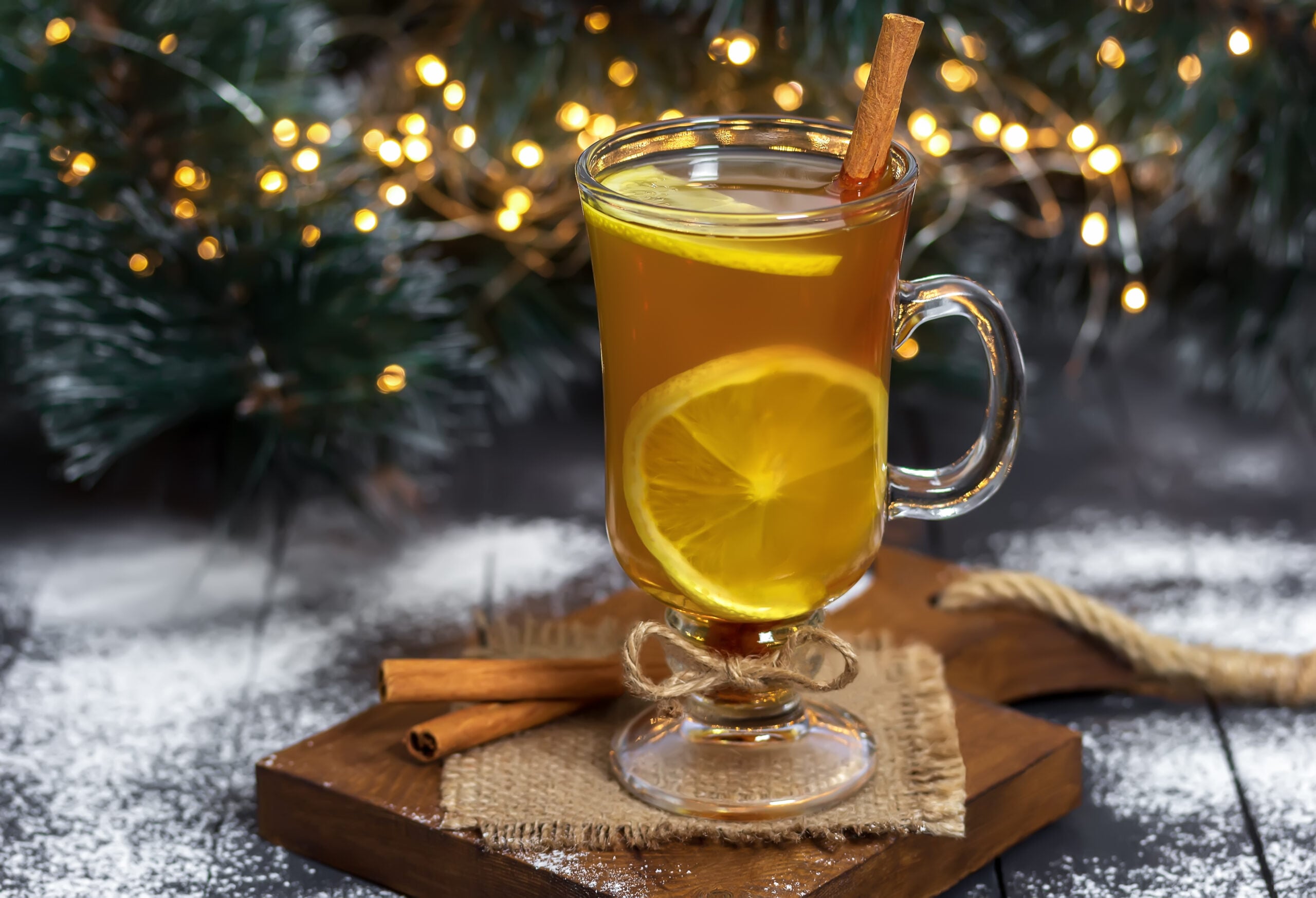  Hot Toddy glass on a wooden Christmas-decorated table. 