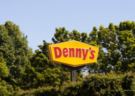 Denny's sign nestled among trees
