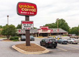 Golden Corral sign and restaurant with cars in front