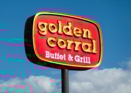 Golden Corral Buffet & Grill sign with blue sky and clouds in the background