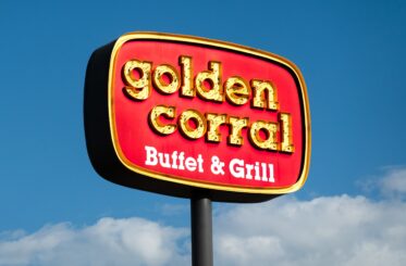 Golden Corral Buffet & Grill sign with blue sky and clouds in the background