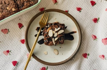 Costco fudge brownie with a fork on a saucer.