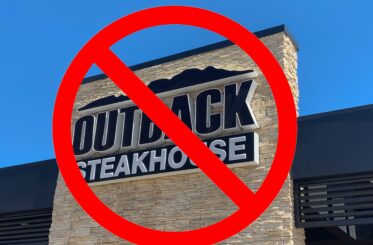Outback Steakhouse sign with a big red cancel symbol over it