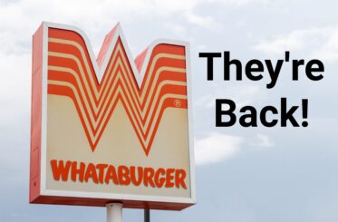 Whataburger sign with "They're Back!" written next to it in black letters