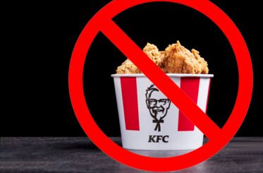 KFC bucket with fried chicken in it covered by a big red cancel sign
