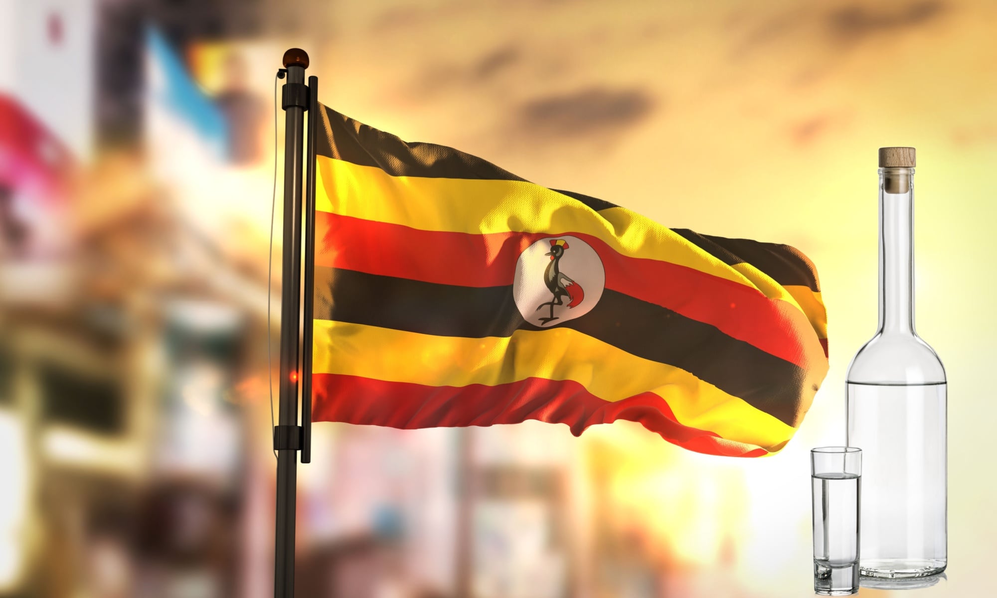The Uganda flag and a bottle of gin on a blurred background, representing Ugandan Waragi.