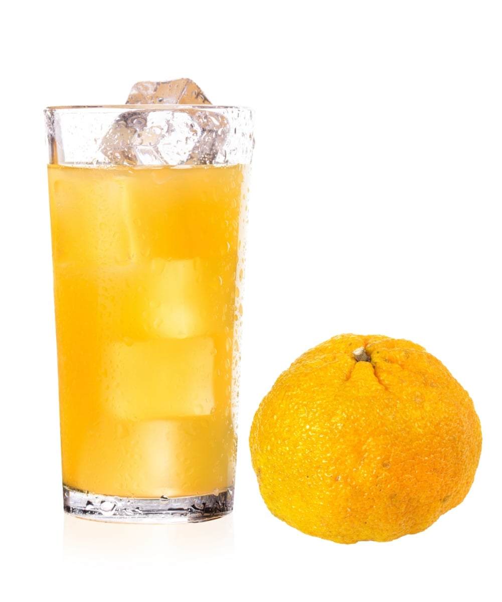 A glass of ugly fruit juice and the ripe fruit. 