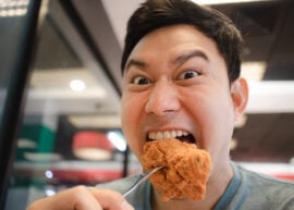 Funny face eating fried chicken