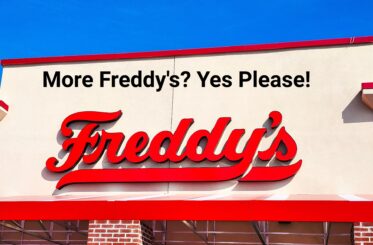Freddy's restaurant sign on a building with "More Freddy's? Yes Please!