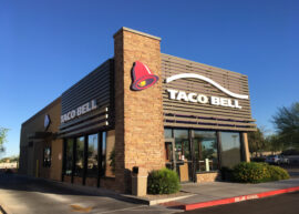 Exterior of a Taco Bell restaurant with clear blue sky.