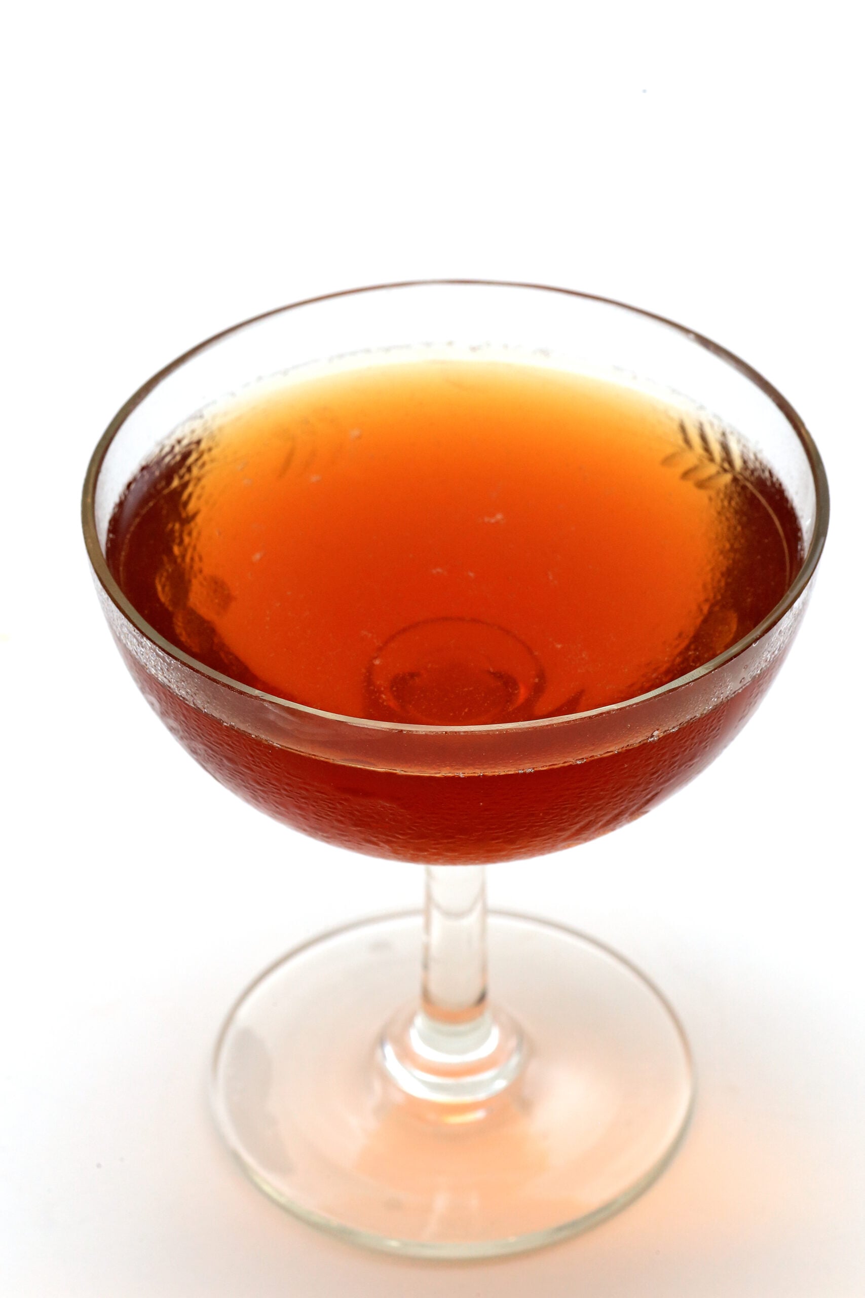 An isolated glass of Norwegian wood cocktail on a white background.