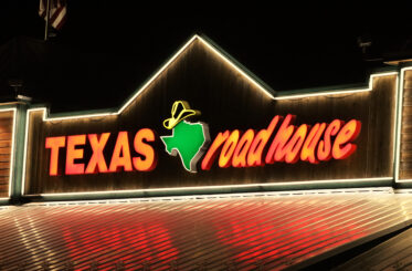 Texas Roadhouse sign lit up at night