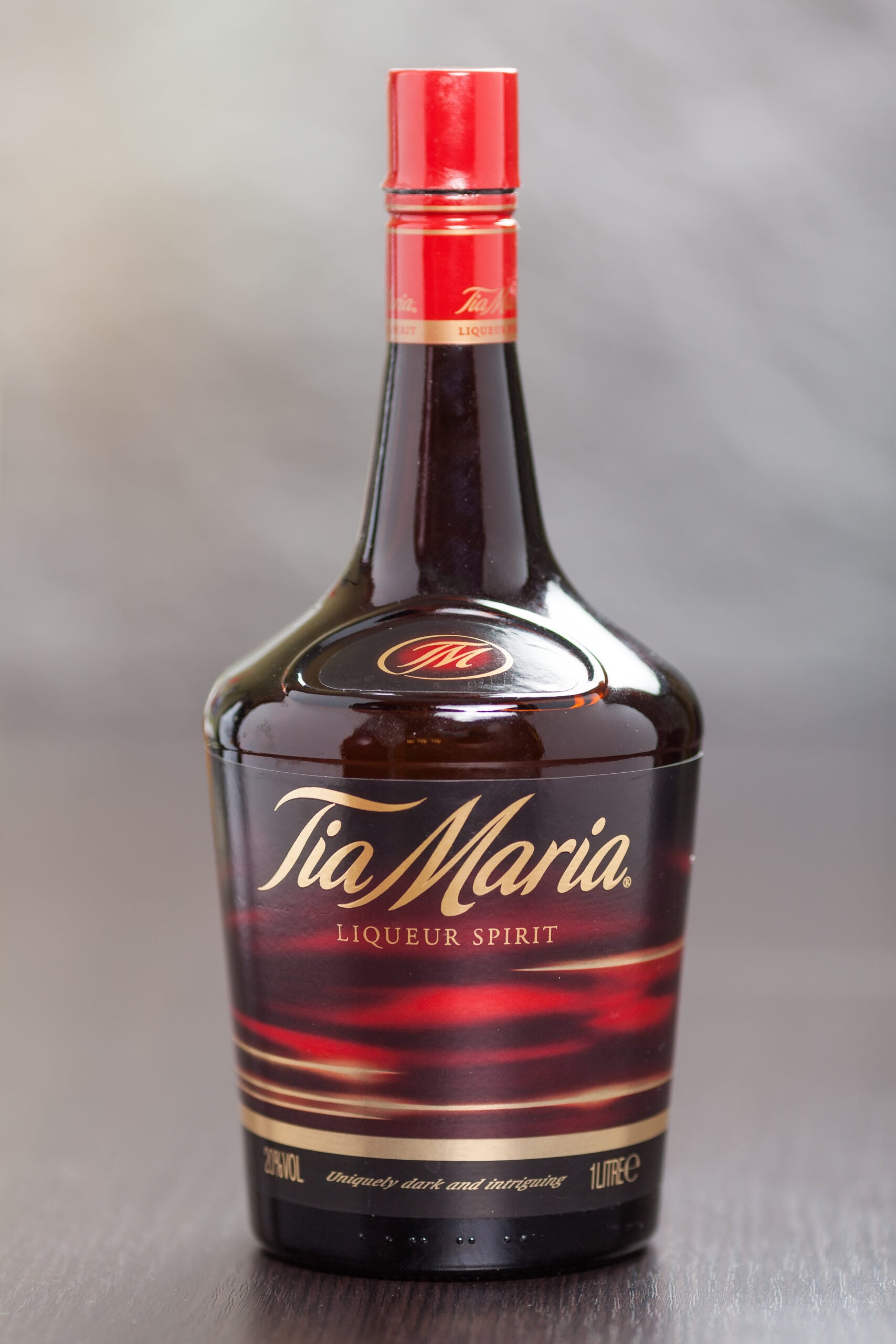 An isolated bottle of Tia Maria coffee liqueur on a blurred background.