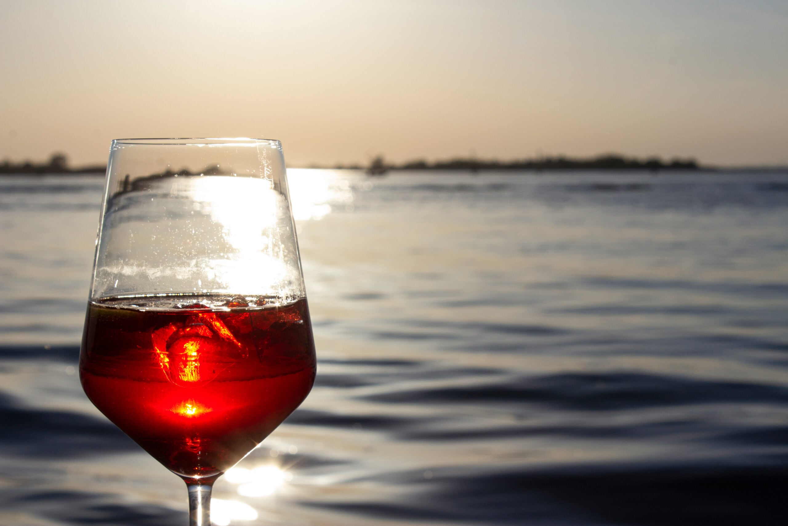 A refreshing Venecian Spritz against a Venecian canal backdrop at sunset.