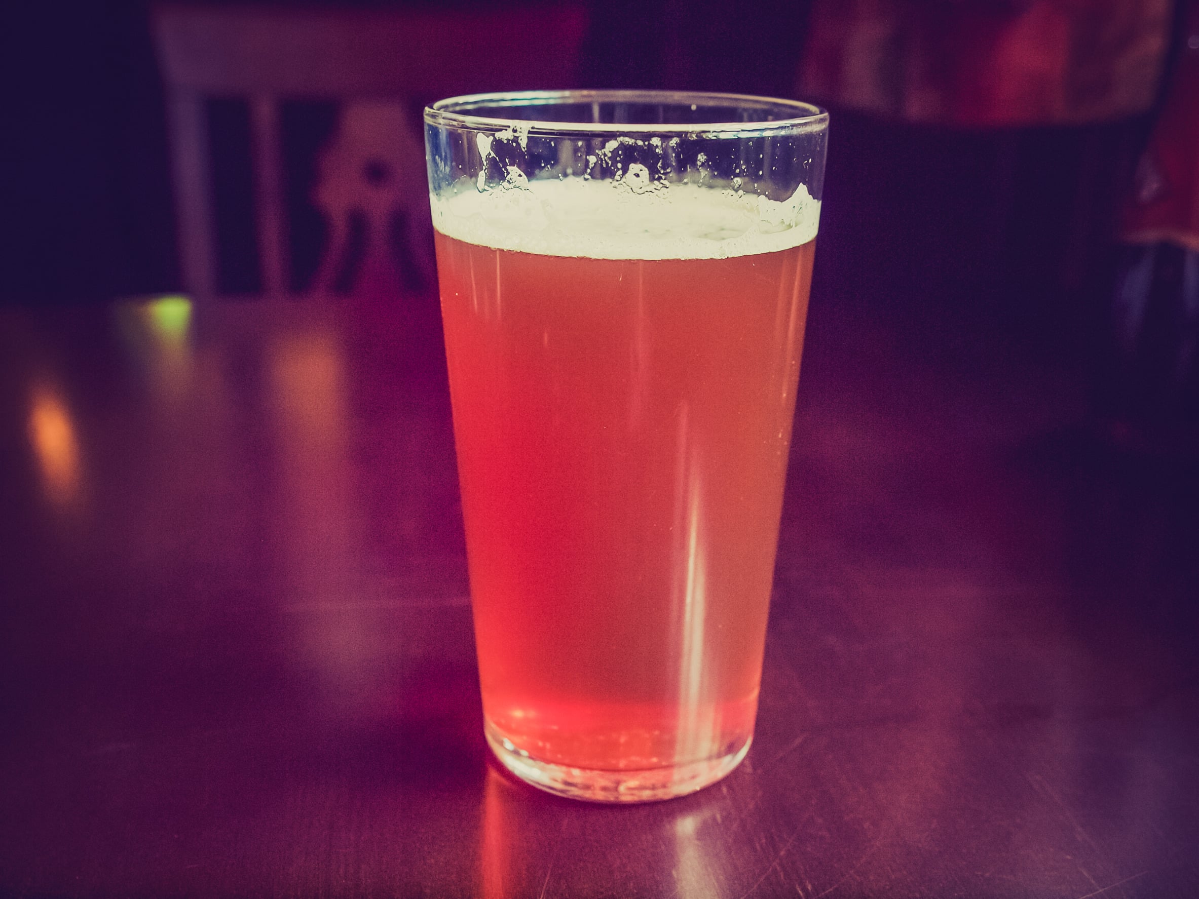 An isolated glass of Queen Mary beer cocktail on a blurred background. 