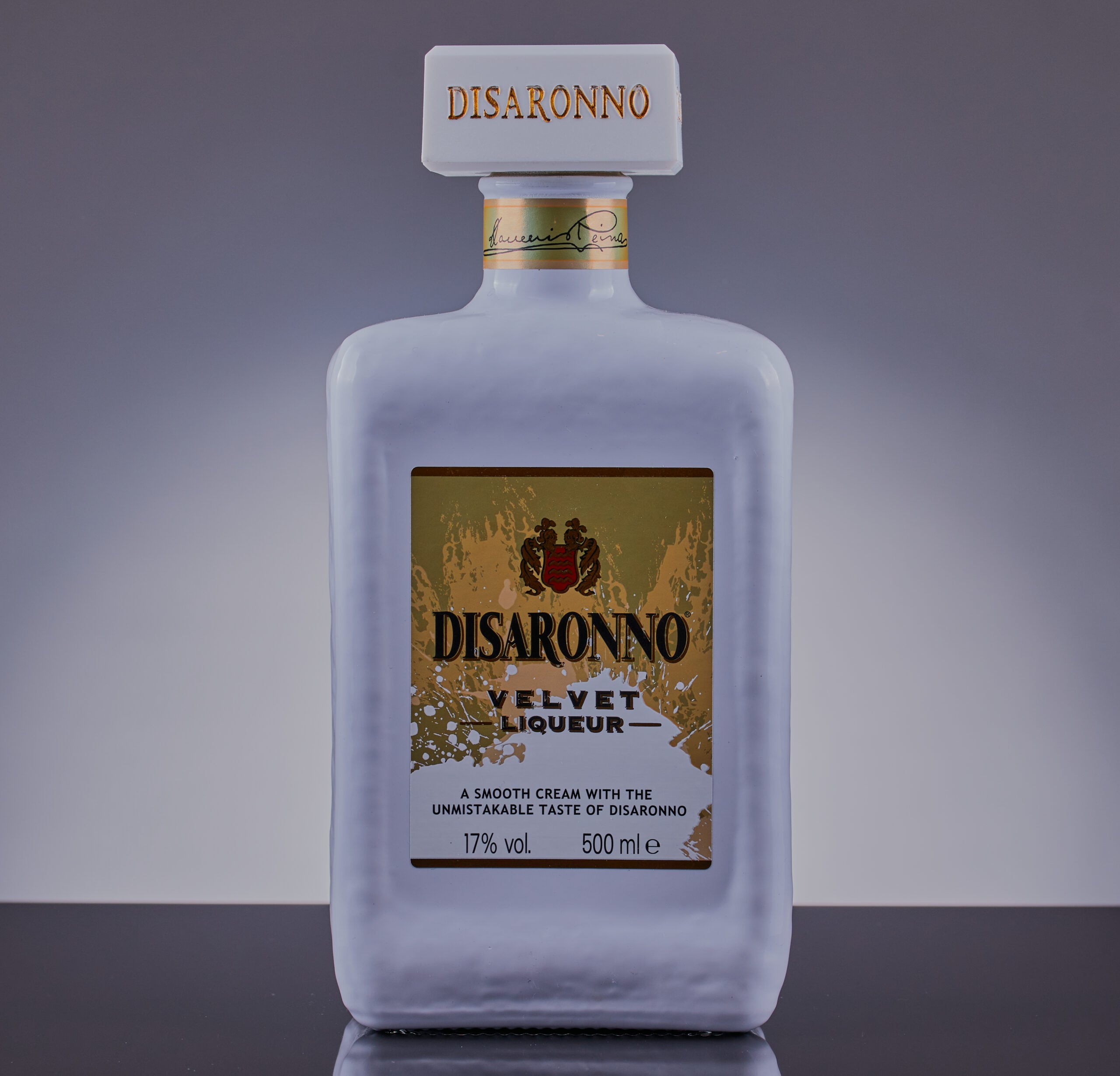 An isolated bottle of velvet cream liqueur on a black surface.