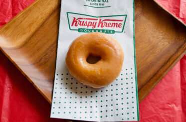Krispy Kreme doughnut on top of a bag