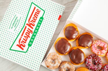 Krispy Kreme donut box with several varieties of donuts inside