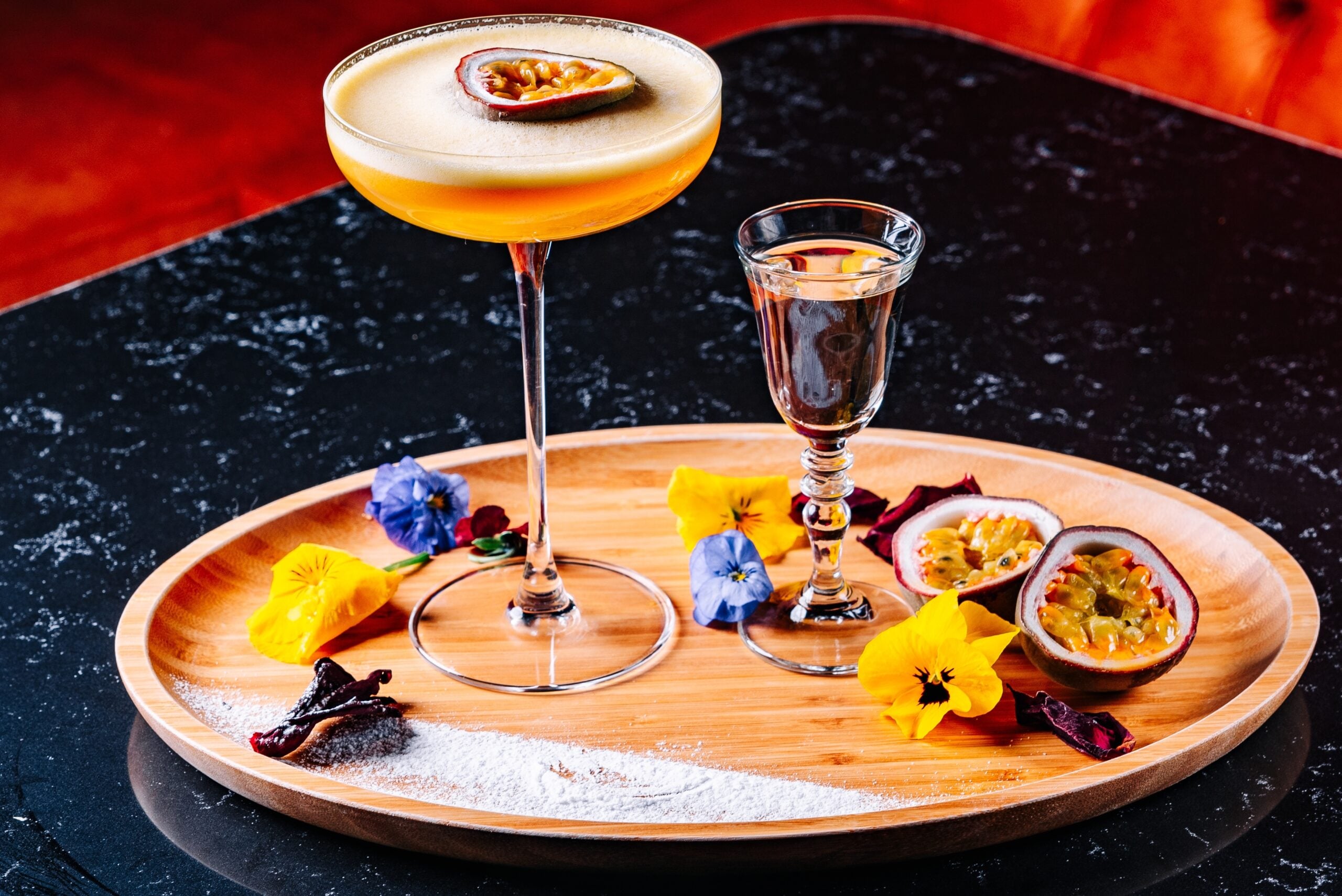 A refreshing pornstar Martini on a wooden tray. 