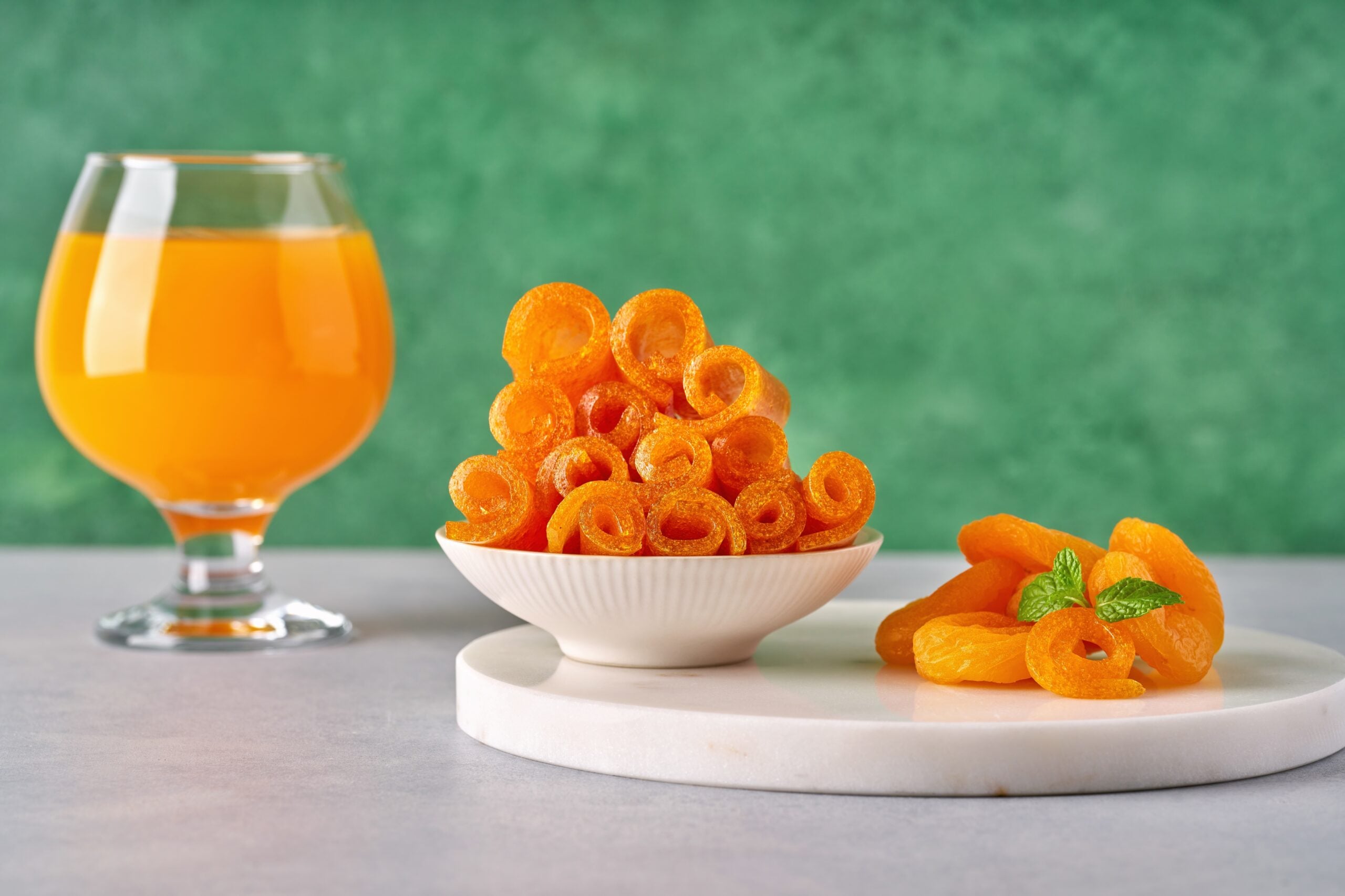 A glass of Qamar al-Din juice, accompanied by dried apricot paste.