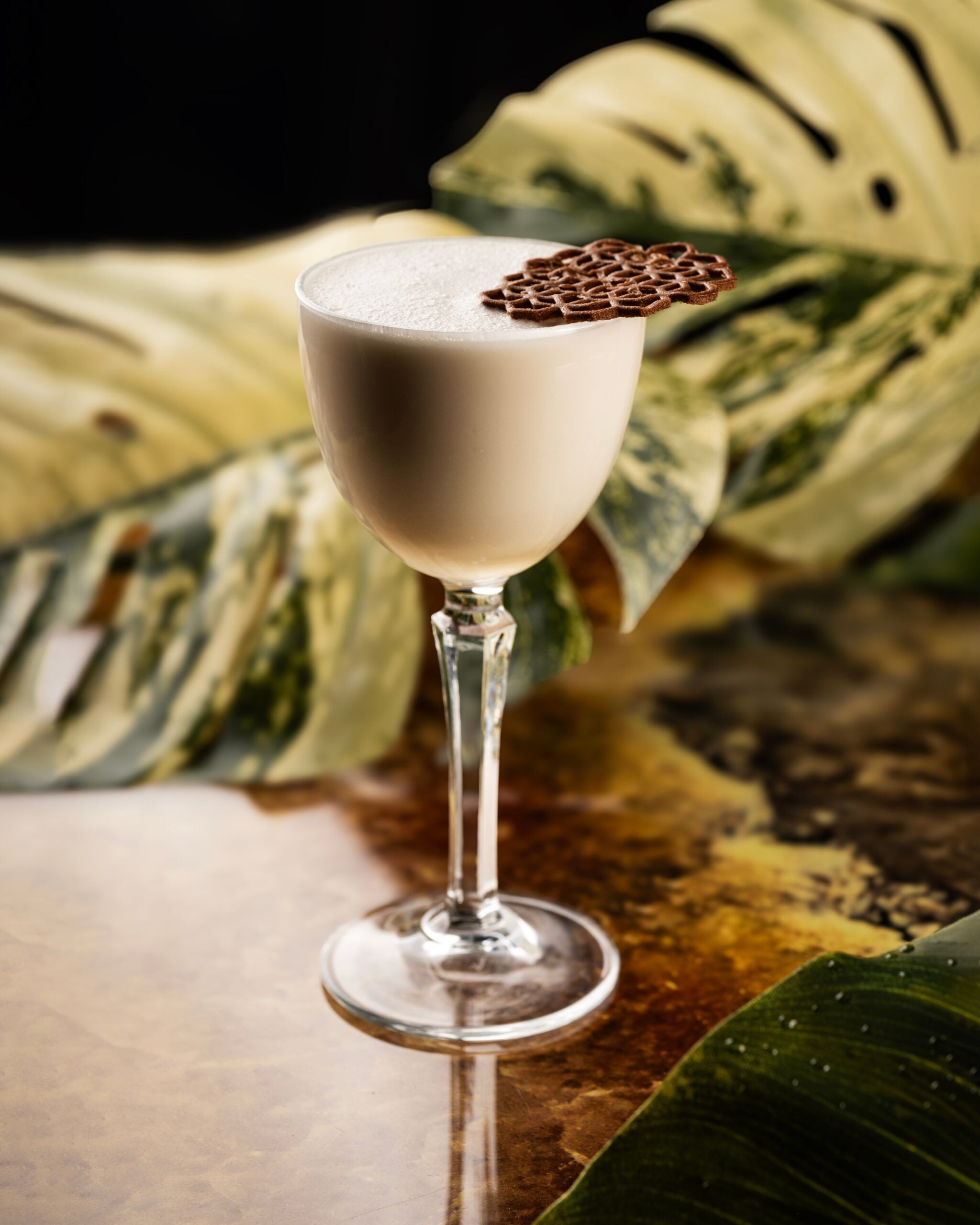 A Nutty Martini topped with a chocolate cookie.