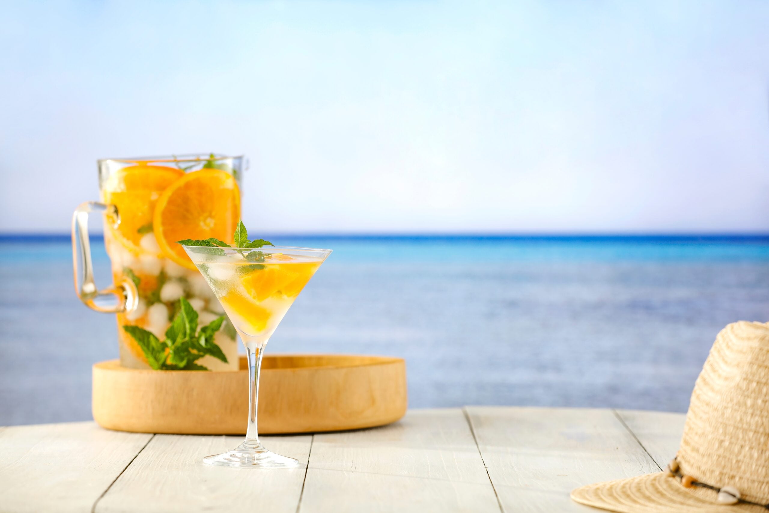 A beautiful sea landscape featuring a freshly made naranjada. 