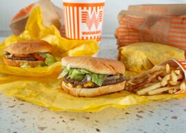 Whataburger burgers with a drink behind and some fries