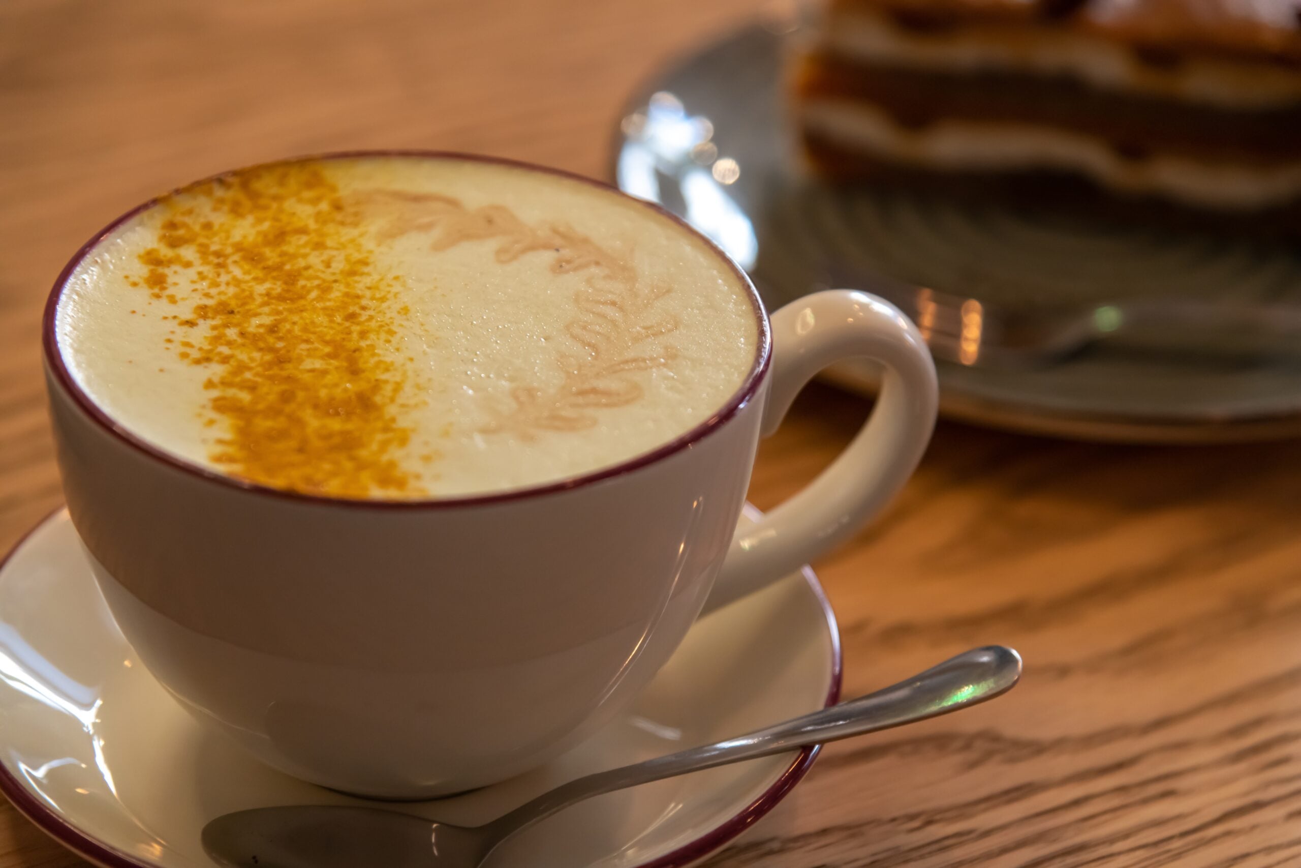 A close-up of a cup of hot nutmeg latte. 