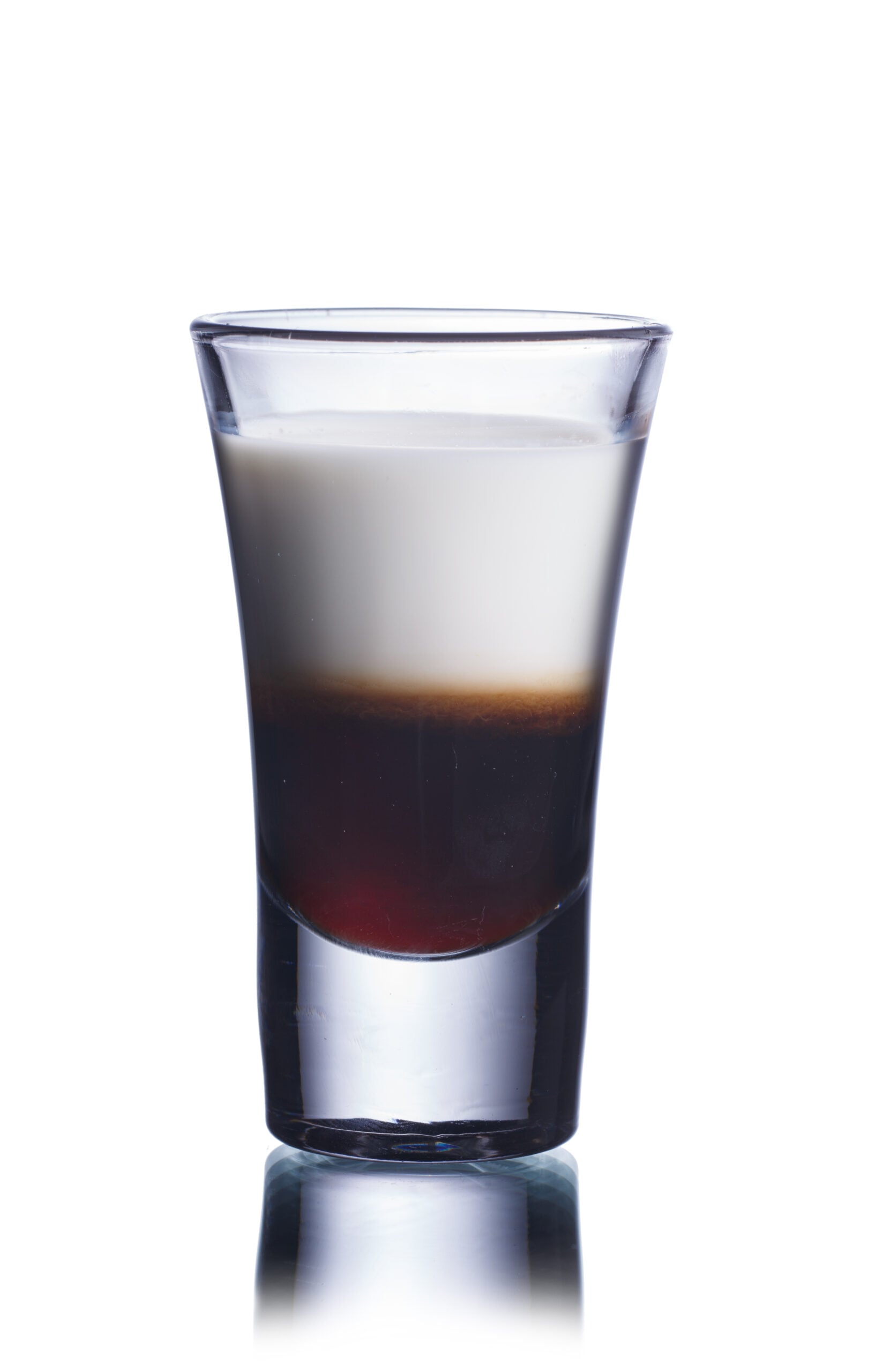 A white backdrop displaying a single glass of Nutcracker shot.