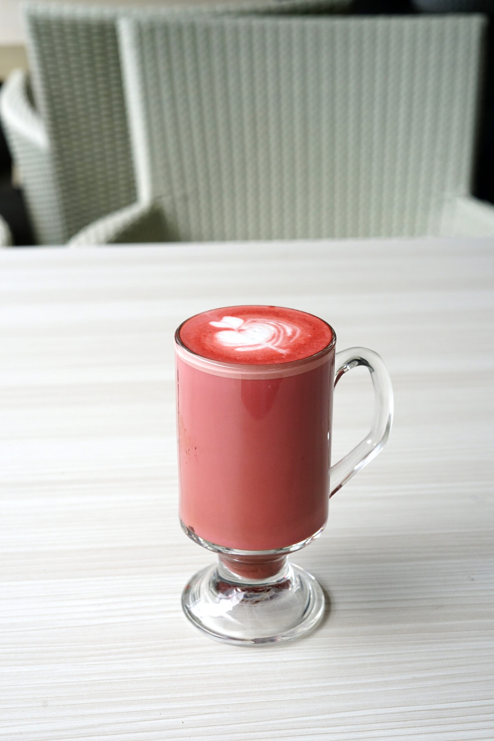 A single cup of red velvet hot chocolate on a blurred background. 