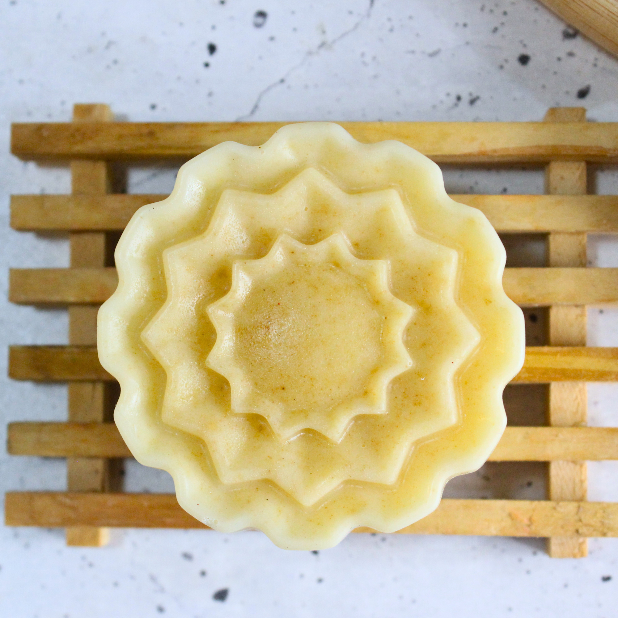 A homemade dish bar of soap on a soap holder. 