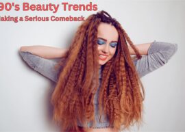 Girl with long red crimped hair and bright blue eyeshadow. The text reads, "90's Beauty Trends Making a Serious Comeback"