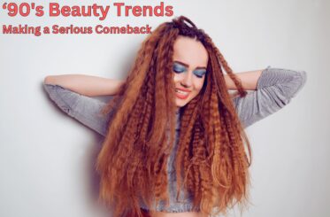 Girl with long red crimped hair and bright blue eyeshadow. The text reads, "90's Beauty Trends Making a Serious Comeback"