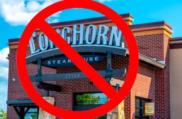 Restaurant facade with a red prohibition symbol overlay.
