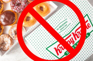 Krispy Kreme box with donuts in it and a big red cancel sign over it